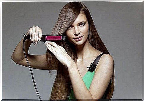 Woman using a hair straightener