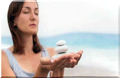 Woman collecting stones from the beach