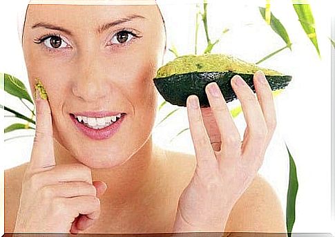 Woman applying an avocado mask