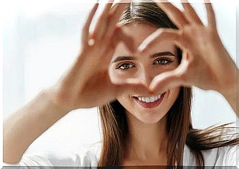 Girl who makes a heart with her hands