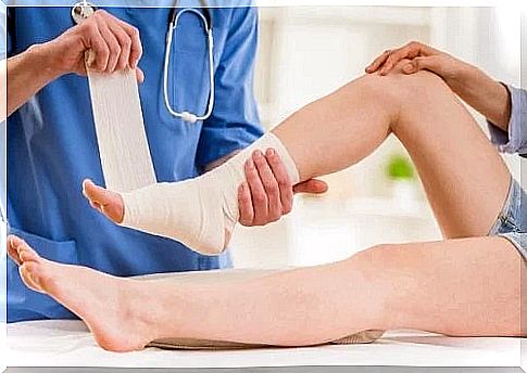 Doctor applying remedies for ankle dislocation