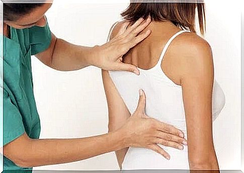 Doctor examining a patient's back