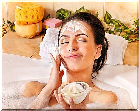 Woman applying natural facial masks during the bath