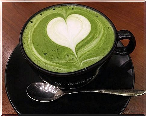 Cup of green tea with heart-shaped foam